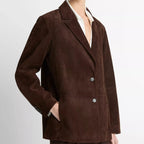 Brown suit jacket worn by a person on a white background