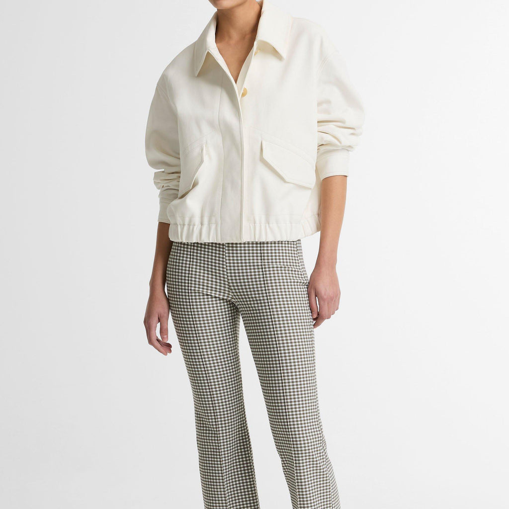 Person wearing a white shirt and checkered pants on a white background